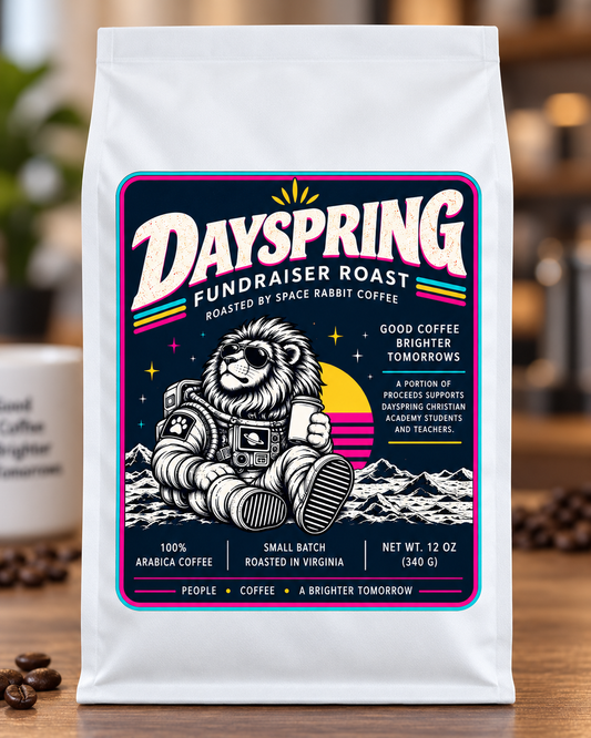 Dayspring Fundraiser Roast white coffee bag with navy astronaut lion label